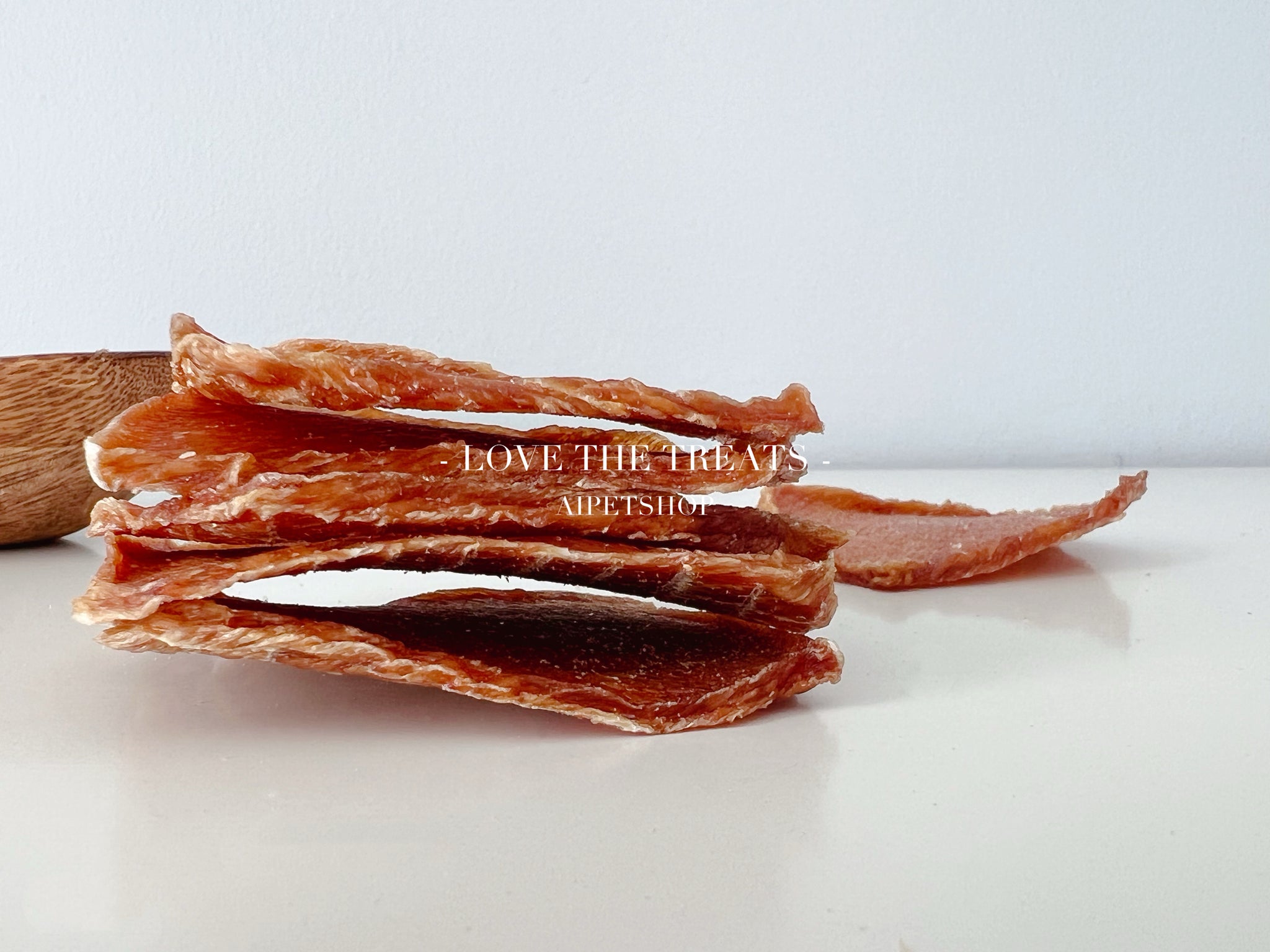 Dog treats on a white surface with 'LOVE THE TREATS' branding.